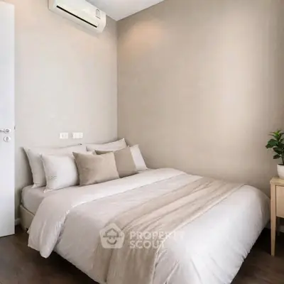 Cozy modern bedroom with neutral tones and air conditioning