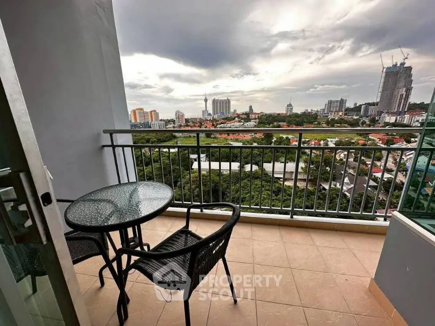 Spacious balcony with stunning city view, perfect for relaxation and outdoor dining.