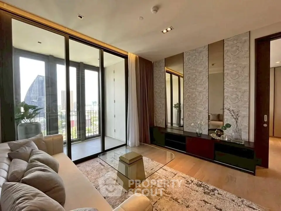 Luxurious living room with modern decor and balcony view in high-rise apartment.