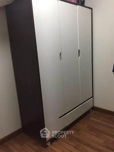 Spacious wardrobe in a modern bedroom with wooden flooring, perfect for ample storage.