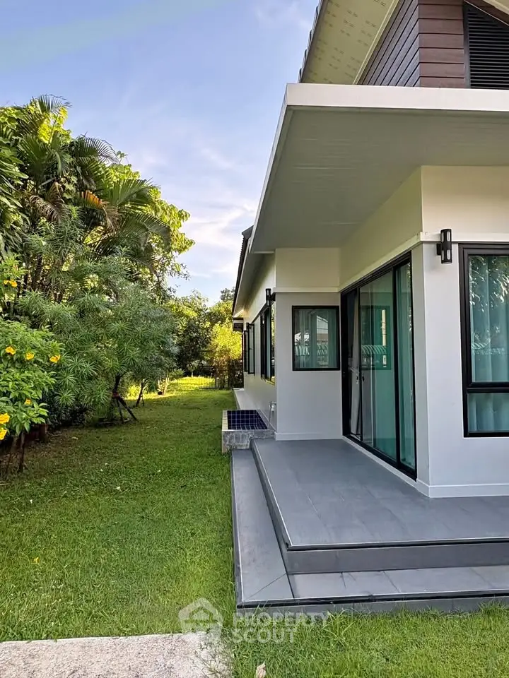 Modern house exterior with lush garden and sleek design