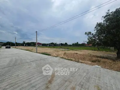 Spacious vacant land with paved road access and scenic surroundings, ideal for development opportunities.