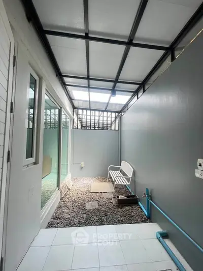 Charming covered patio with modern design and cozy seating area, perfect for relaxation and outdoor enjoyment.