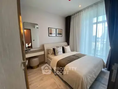 Modern bedroom with stylish decor and large window for natural light