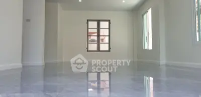 Spacious empty room with glossy marble flooring and large windows