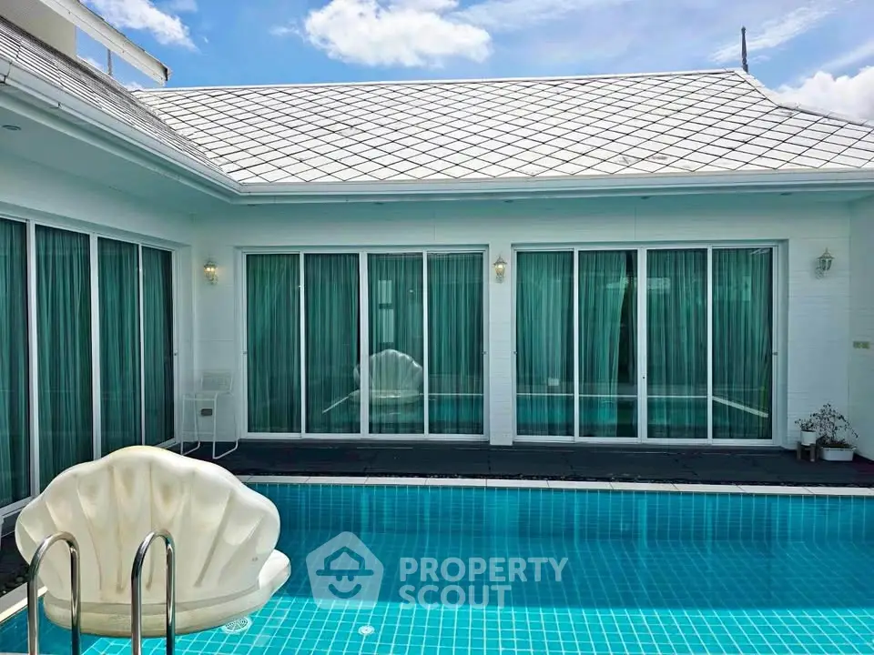 Luxurious villa with private pool and modern architecture under a clear blue sky.