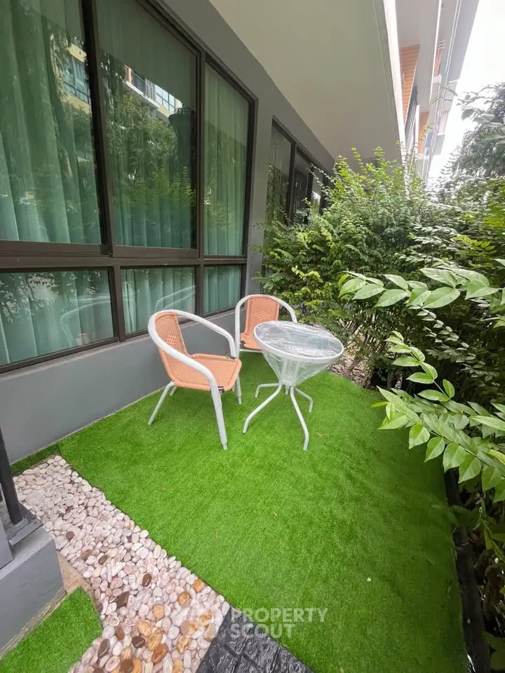 Charming garden patio with cozy seating, perfect for relaxation and outdoor enjoyment.