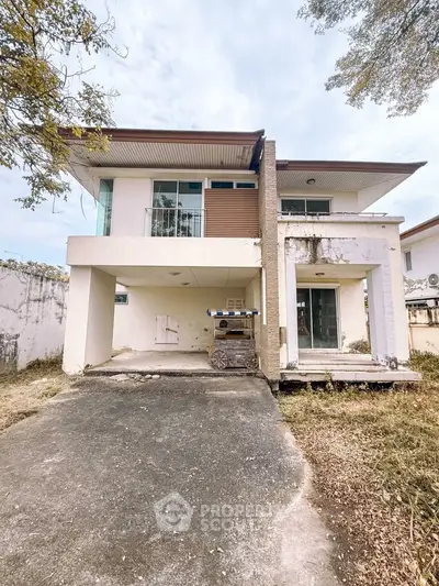 Spacious two-story house with modern design and large driveway, perfect for family living.