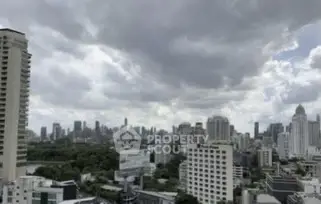 Stunning cityscape view from high-rise building with dramatic cloudy sky.