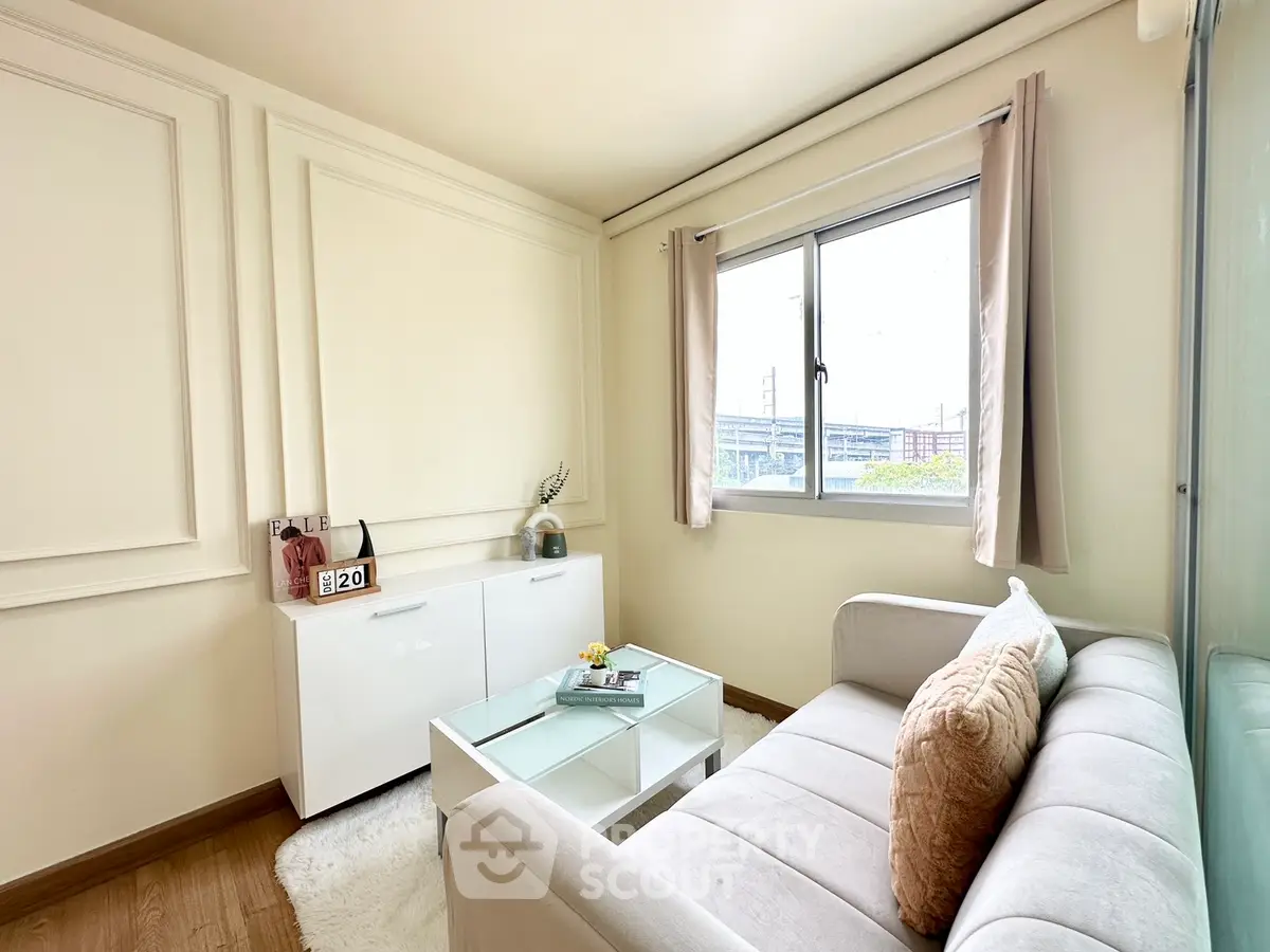 Cozy living room with elegant decor and natural light, featuring a plush sofa and modern coffee table.