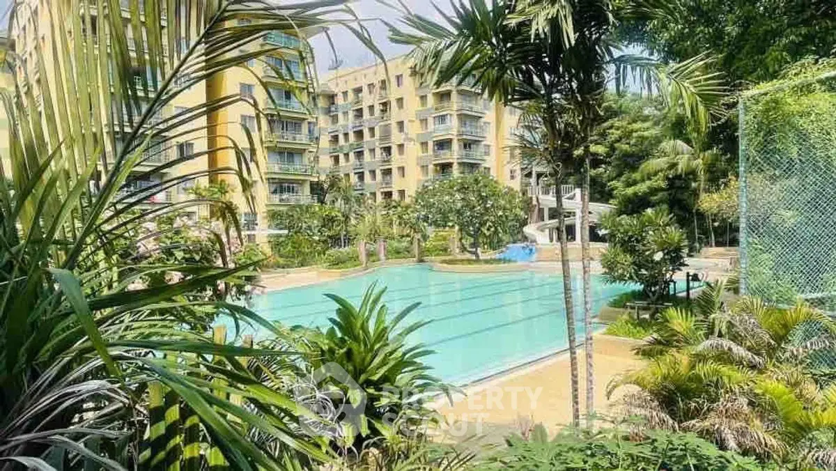 Luxurious apartment complex with a stunning outdoor pool and lush greenery, perfect for relaxation and leisure.
