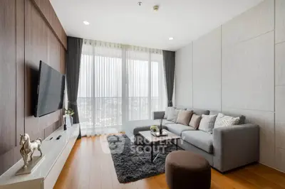 Modern living room with stylish decor and large windows offering natural light.
