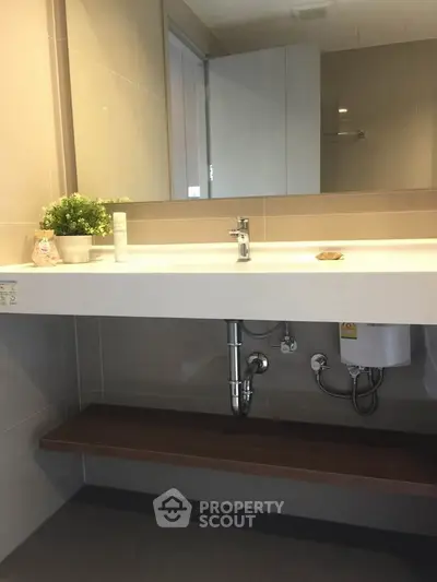 Modern bathroom with sleek sink and under-sink storage