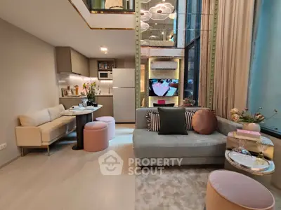 Modern living room with open kitchen, stylish decor, and large windows for natural light.