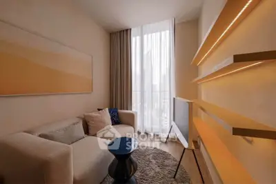 Modern living room with stylish decor and city view, featuring a cozy sofa and sleek shelving.