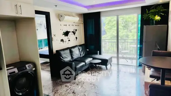 Modern living room with balcony, sleek furniture, and washing machine in stylish apartment.