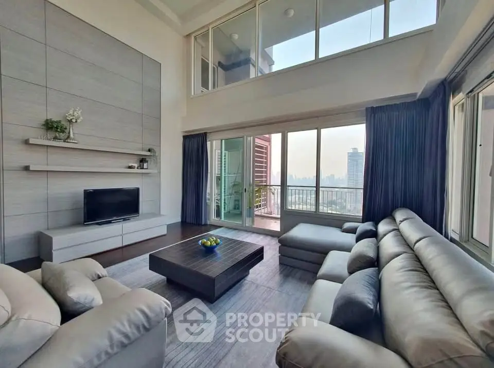 Spacious modern living room with large windows and city view