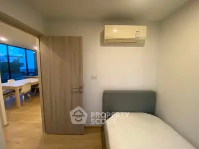 Cozy bedroom with air conditioning and view into modern dining area