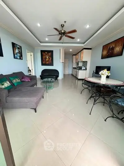 Spacious living room with modern decor and open kitchen layout, perfect for entertaining.