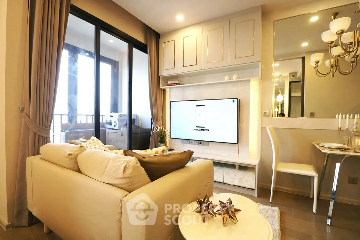 Luxurious living room with elegant decor and large TV, featuring a cozy sofa and stylish dining area.
