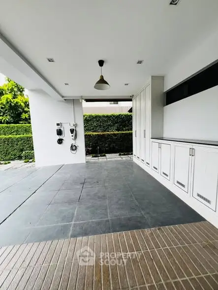 Modern garage with electric vehicle charging stations and sleek cabinetry