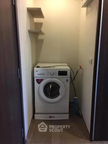 Compact laundry space with modern washing machine in cozy apartment.