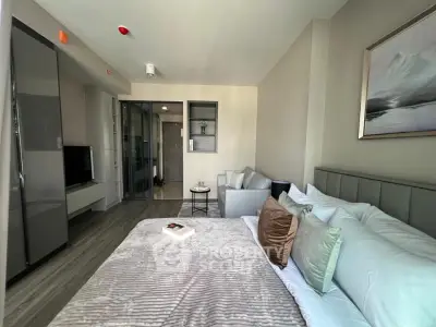 Modern bedroom with stylish decor and cozy ambiance, featuring a plush bed and sleek furniture.