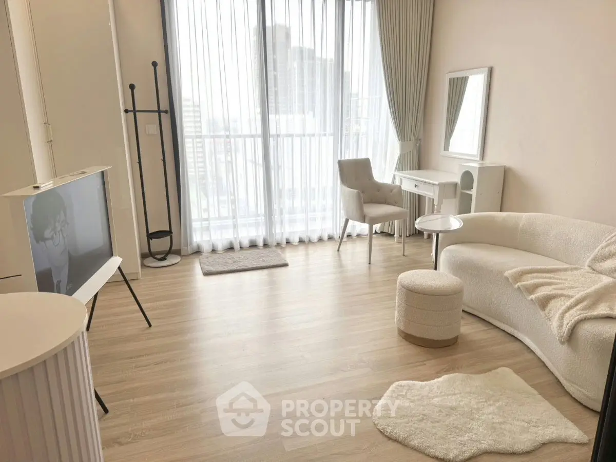 Modern living room with elegant decor and city view, featuring cozy seating and natural light.