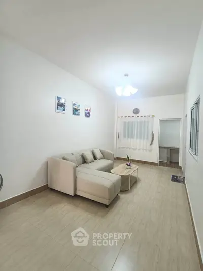 Spacious living room with modern sofa and elegant decor in a bright apartment.