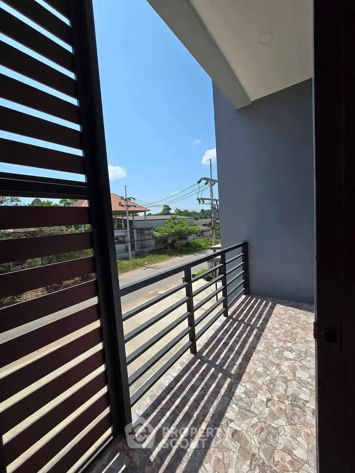 Charming balcony with modern railing and scenic view, perfect for relaxation and enjoying the outdoors.