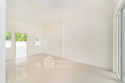 Spacious empty room with large windows and glossy floor, perfect for customization.