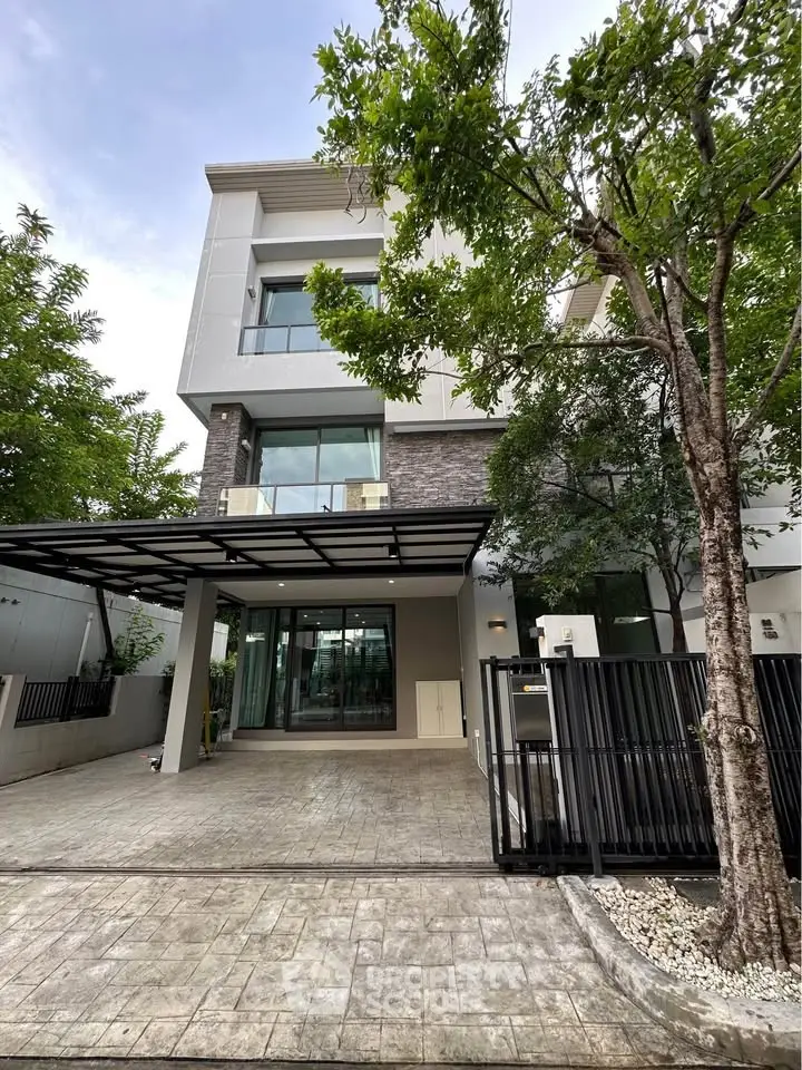 Modern three-story house with sleek design and spacious driveway