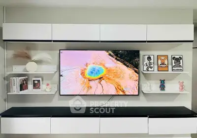 Modern living room with sleek wall-mounted TV and stylish shelving decor