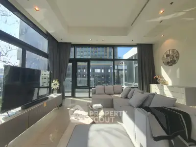 Luxurious modern living room with large windows and stylish decor in urban apartment