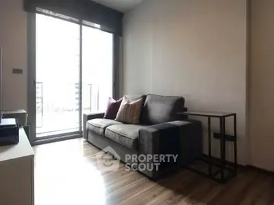 Modern living room with sleek sofa and balcony view in urban apartment
