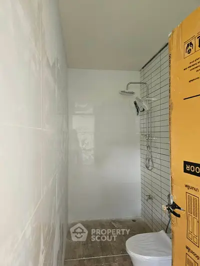 Compact bathroom with shower and toilet in modern minimalist design