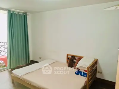 Cozy bedroom with simple decor and natural light, ideal for restful nights.