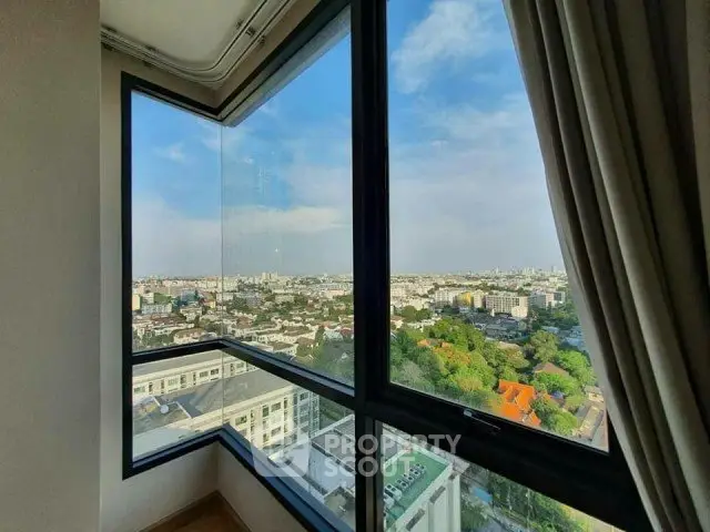 Stunning corner unit with panoramic city view from high-rise window.