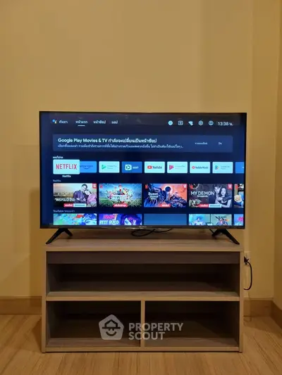 Modern living room with sleek TV setup on stylish wooden stand, perfect for entertainment enthusiasts.