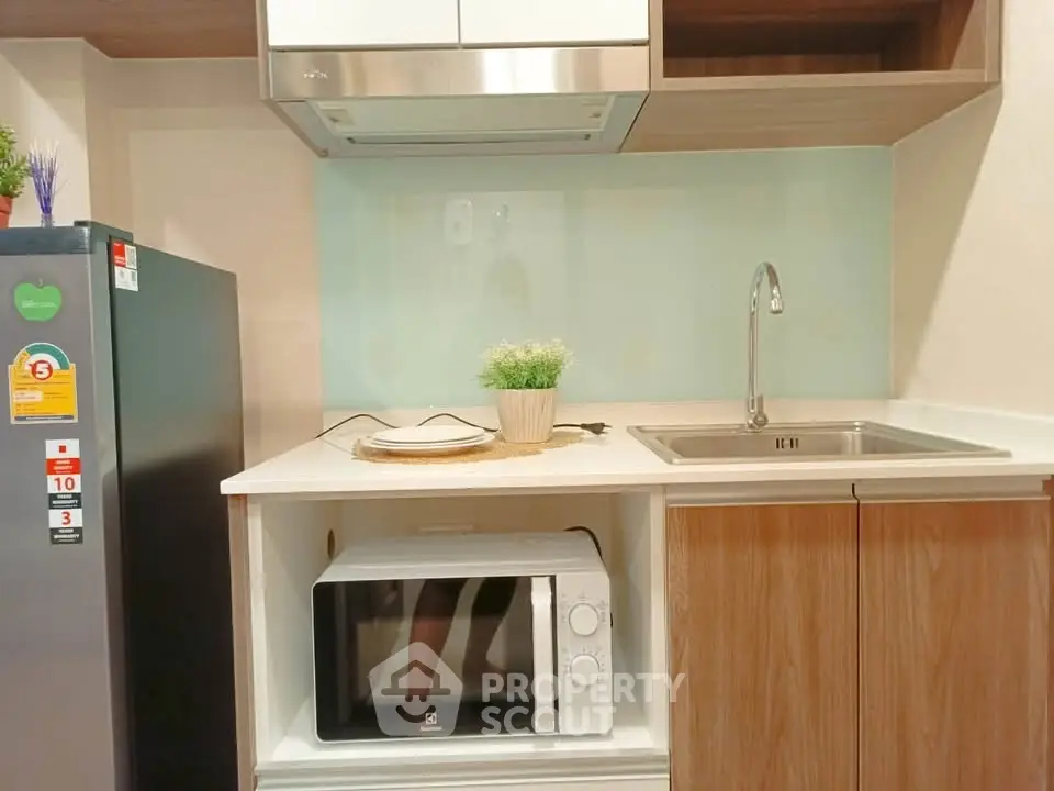 Modern kitchen with sleek appliances and stylish cabinetry, perfect for urban living.