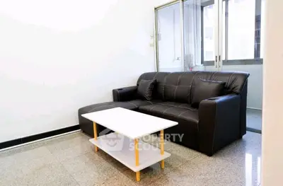 Modern living room with sleek black sofa and minimalist coffee table
