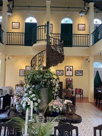 Charming vintage interior with spiral staircase and elegant decor in a historic building.