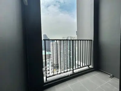 Modern high-rise balcony with stunning cityscape view, perfect for urban living enthusiasts.