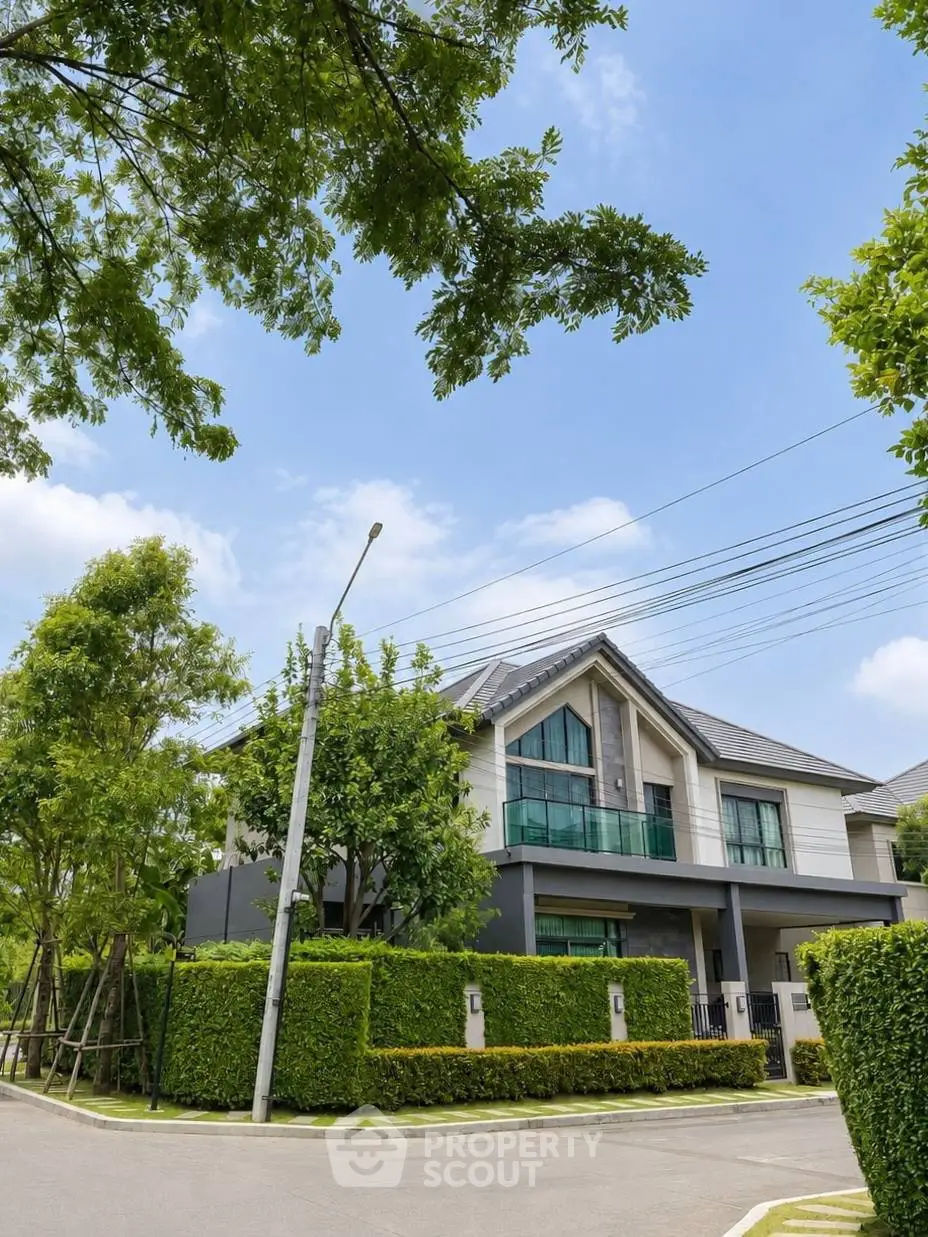 Stunning modern house with lush greenery and sleek architecture in a serene neighborhood.