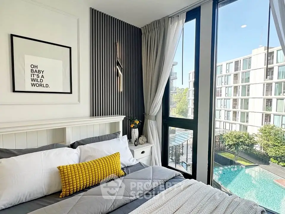 Modern bedroom with large windows offering a stunning pool view in a luxury apartment.