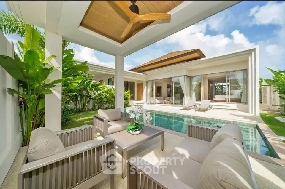 Luxurious villa with private pool and elegant outdoor seating area, perfect for relaxation.