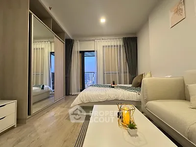 Modern bedroom with stylish decor and large mirrored wardrobe in a cozy apartment.