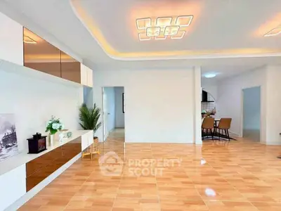 Spacious modern living room with elegant lighting and open dining area