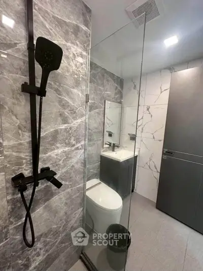 Modern bathroom with sleek shower and elegant marble tiles