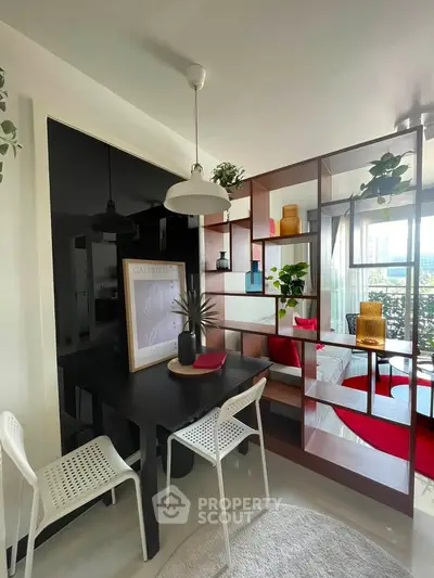 Modern dining area with stylish decor and open shelving in a bright apartment.